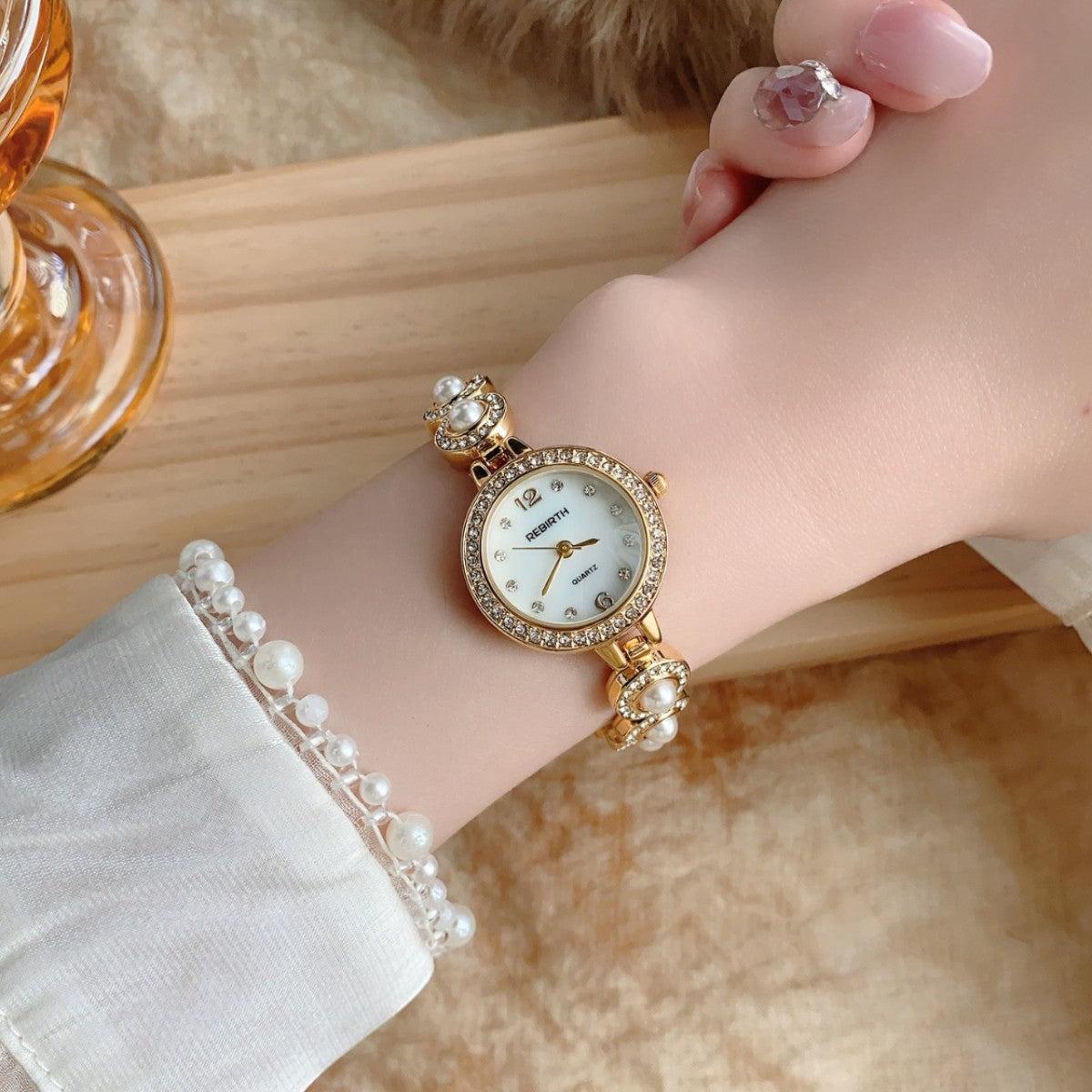 REGIRTH pearl crystal-style round bracelet watch in gold tone