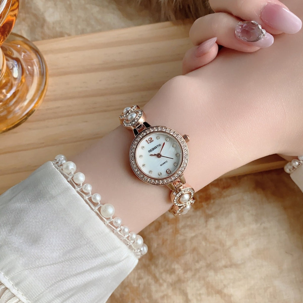 REGIRTH pearl crystal-style round bracelet watch in rose gold tone on wrist