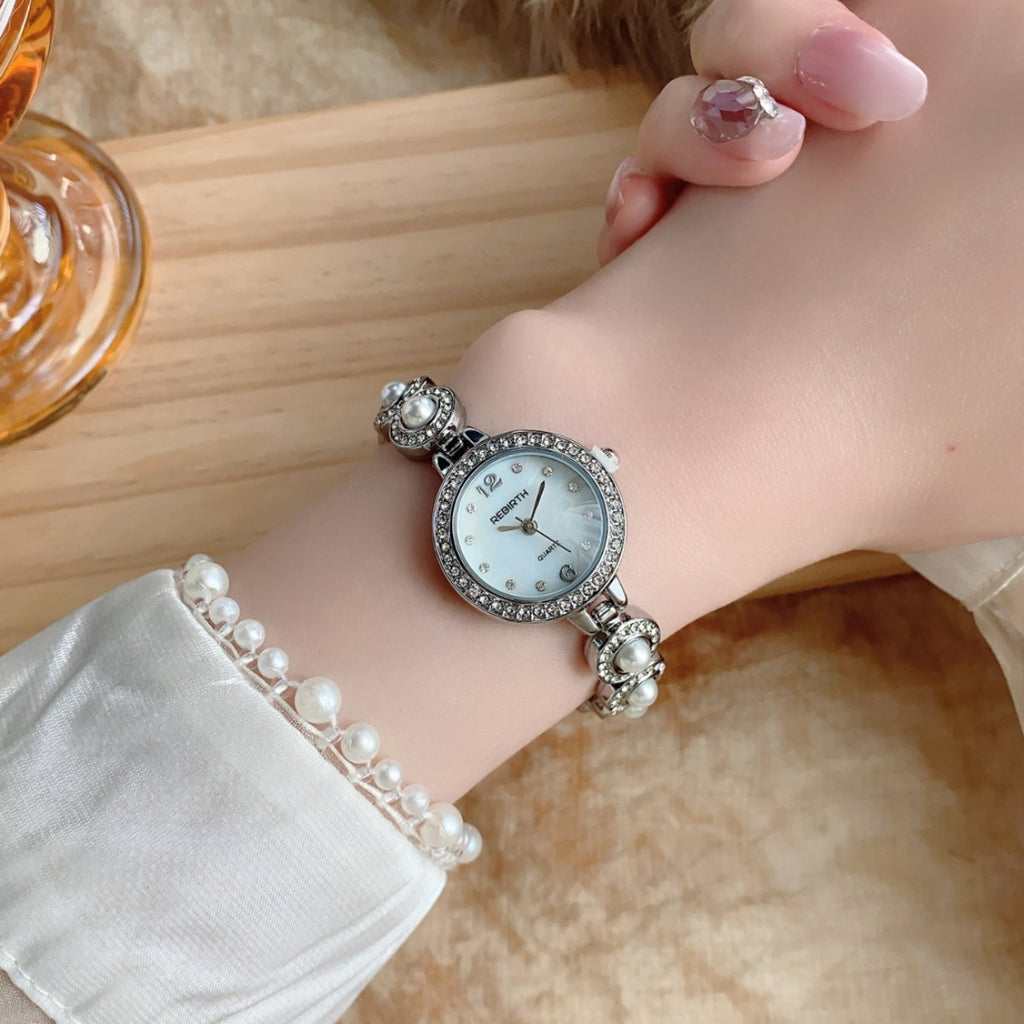 REGIRTH pearl crystal-style round bracelet watch in silver tone on wrist