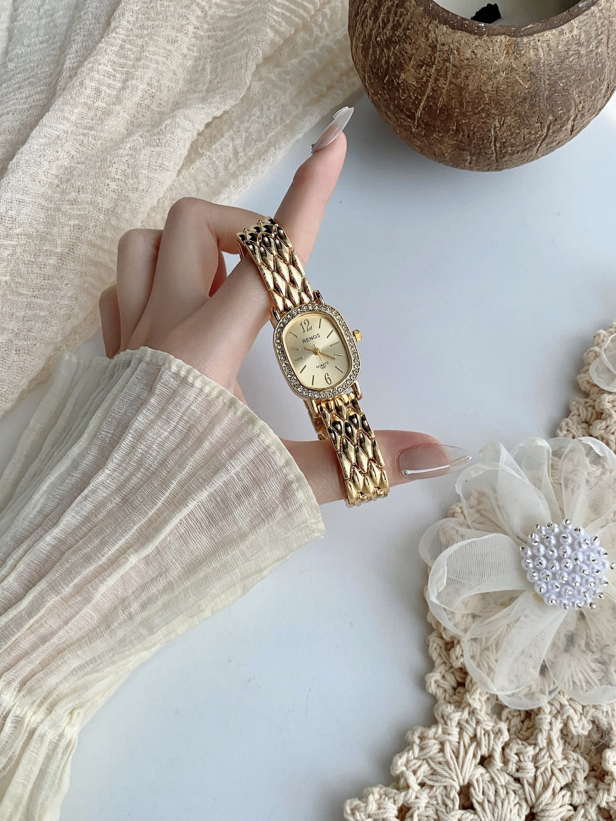 RENOS crystal-style cushion watch in gold tone with champagne dial full view