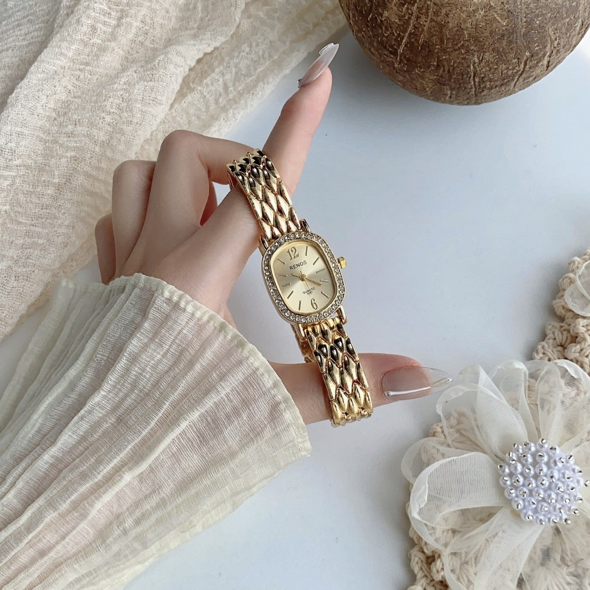 RENOS crystal-style cushion watch in gold tone with champagne dial
