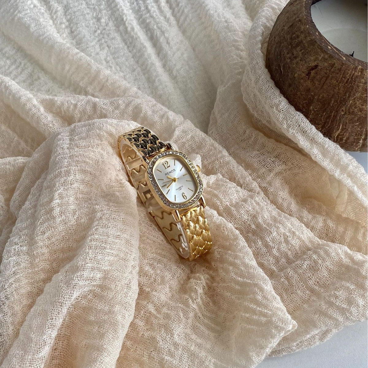 RENOS crystal-style cushion watch in gold tone with white dial lifestyle view