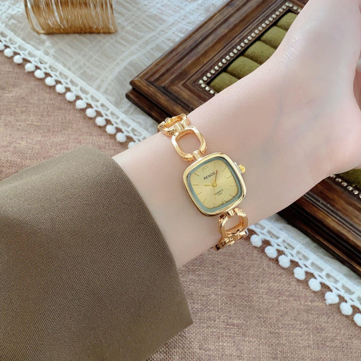 RENOS open-link cushion bracelet watch in gold tone with champagne dial