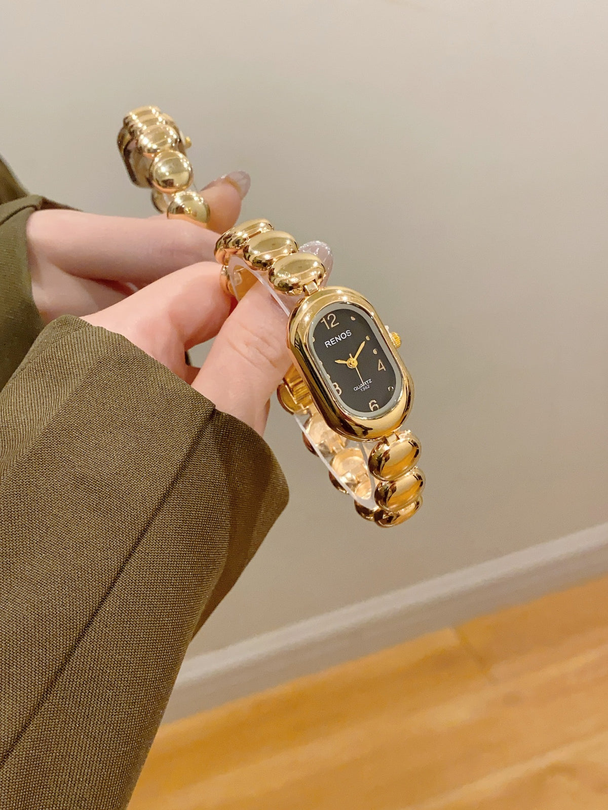 RENOS women's oval bead bracelet quartz watch in gold tone with black dial