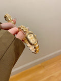 RENOS women's oval bead bracelet quartz watch in gold tone with ivory dial