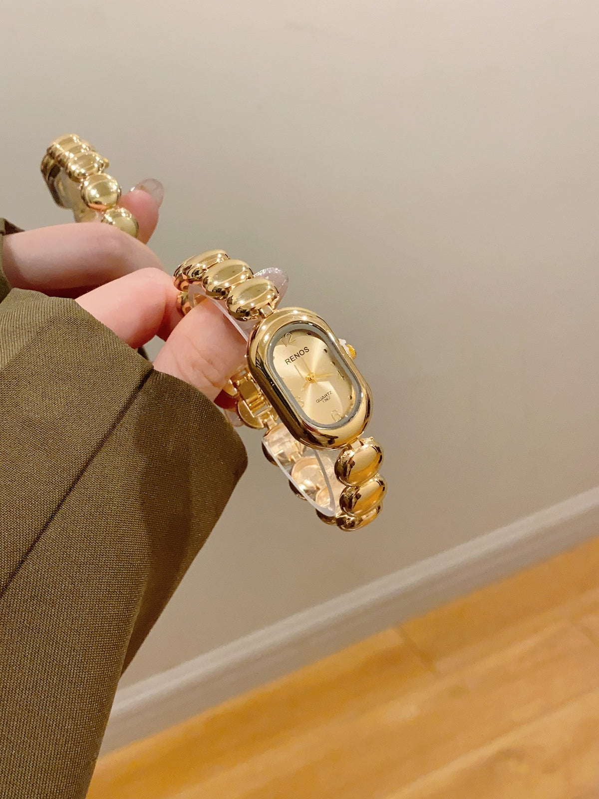 RENOS women's oval bead bracelet quartz watch in gold tone with ivory dial