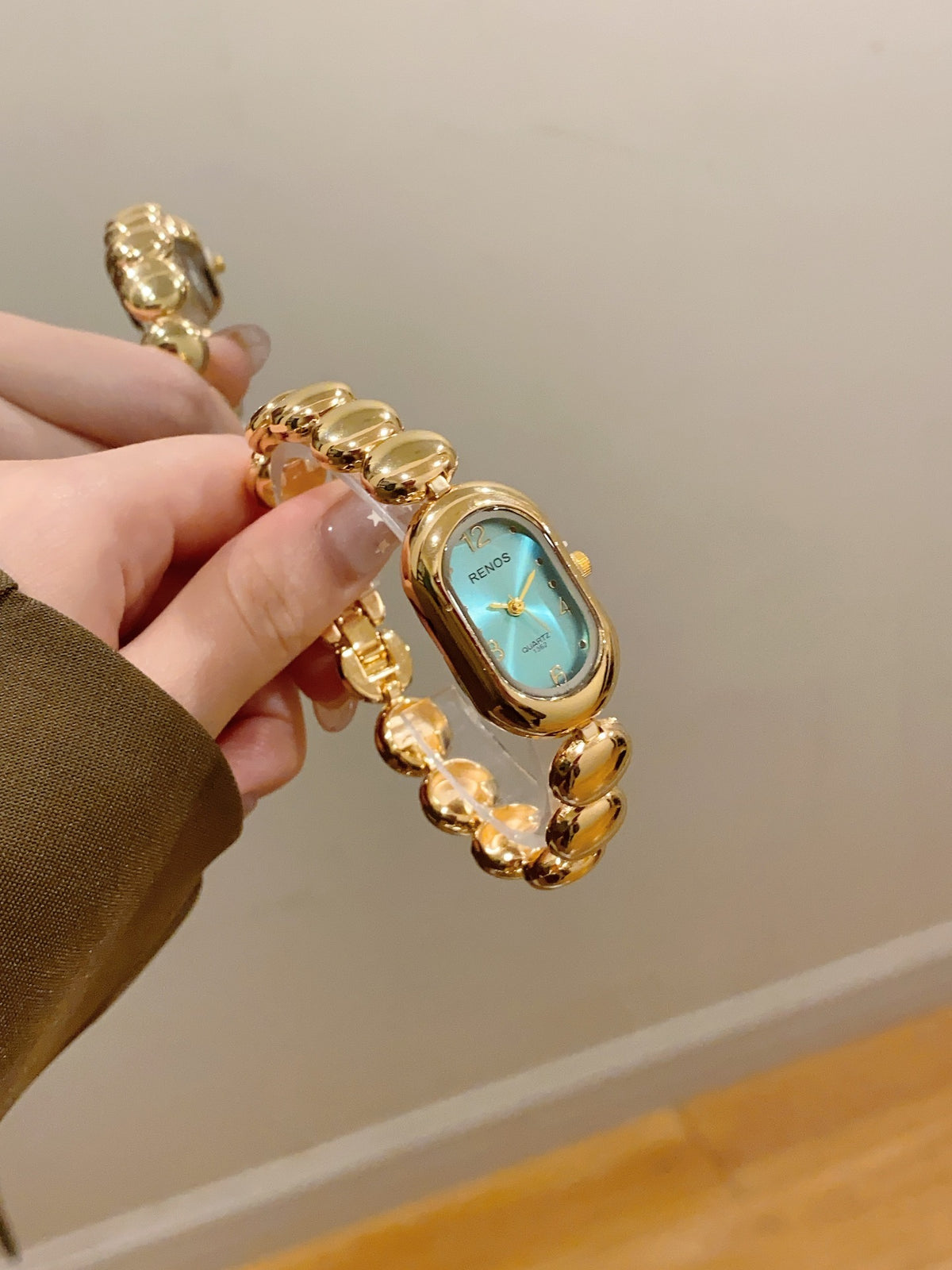 RENOS women's oval bead bracelet quartz watch in gold tone with turquoise dial