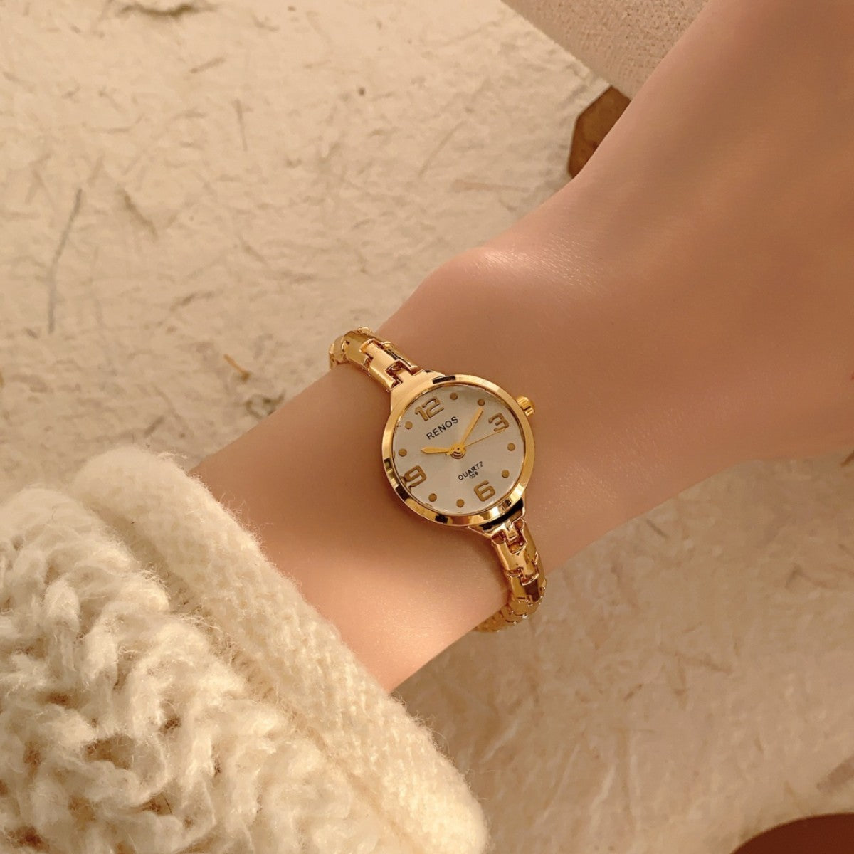 RENOS petite round gold-tone jewelry bracelet quartz watch with ivory dial