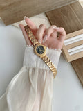 RENOS textured bezel bracelet watch in gold tone with black dial