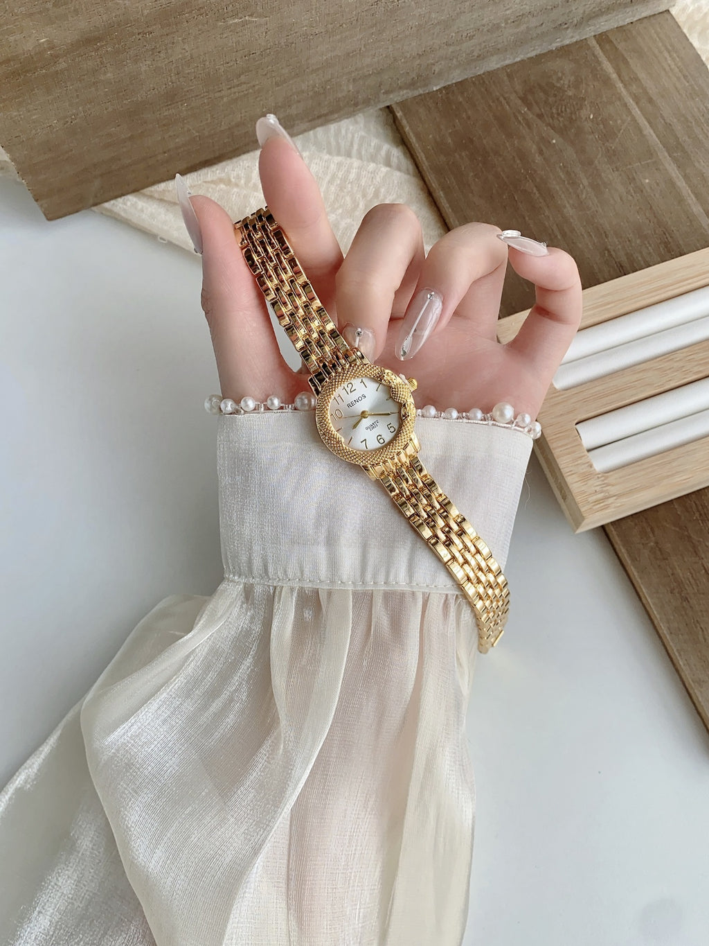 RENOS textured bezel bracelet watch in gold tone with champagne dial alternate view