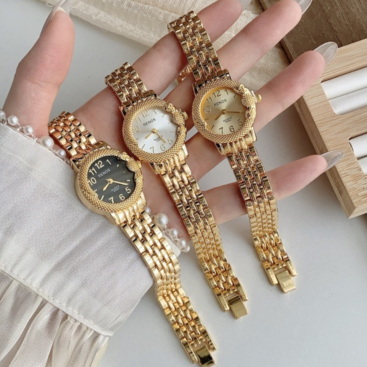 RENOS textured bezel bracelet watches in gold tone with multiple dial colors