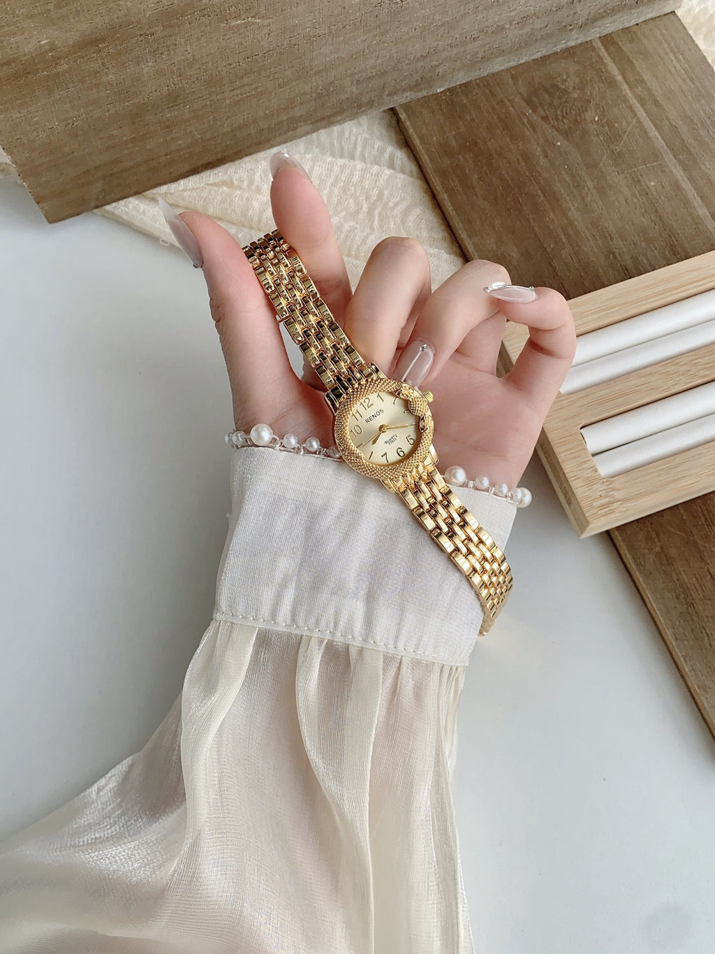 RENOS textured bezel bracelet watch in gold tone with white dial alternate view