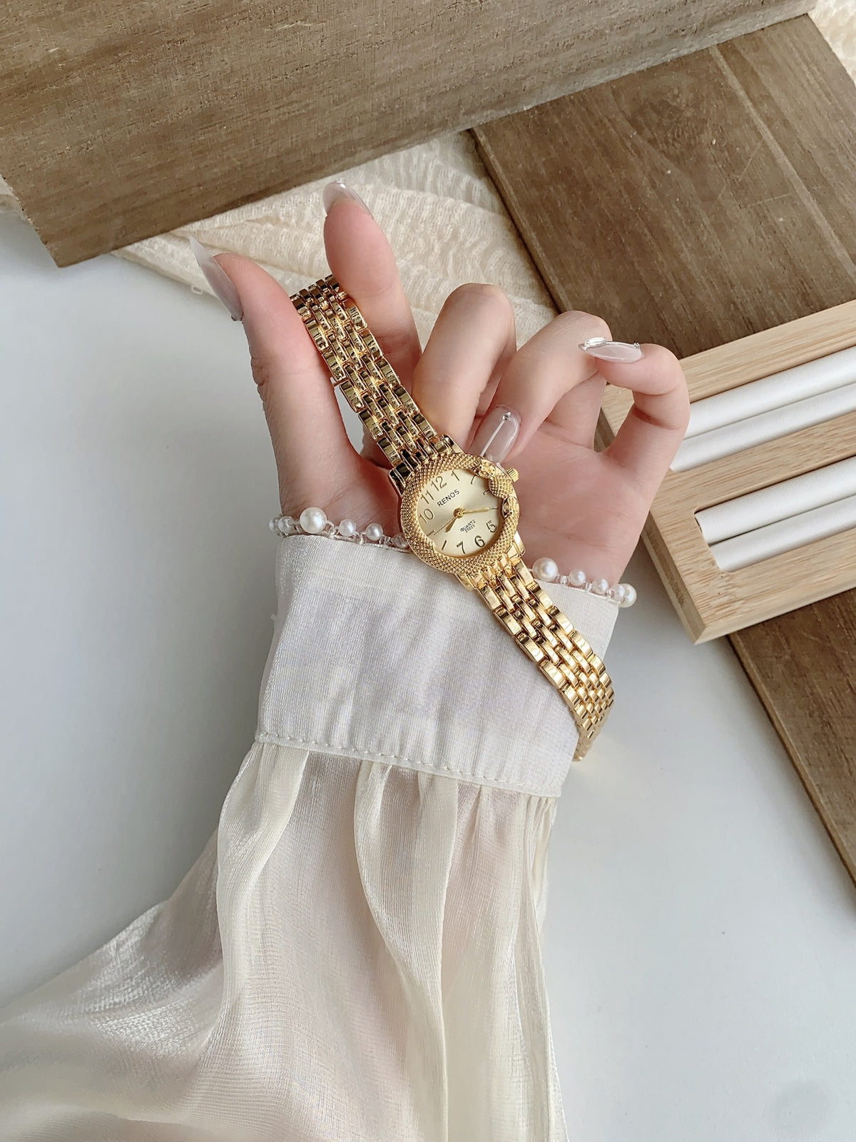 RENOS textured bezel bracelet watch in gold tone with white dial alternate view