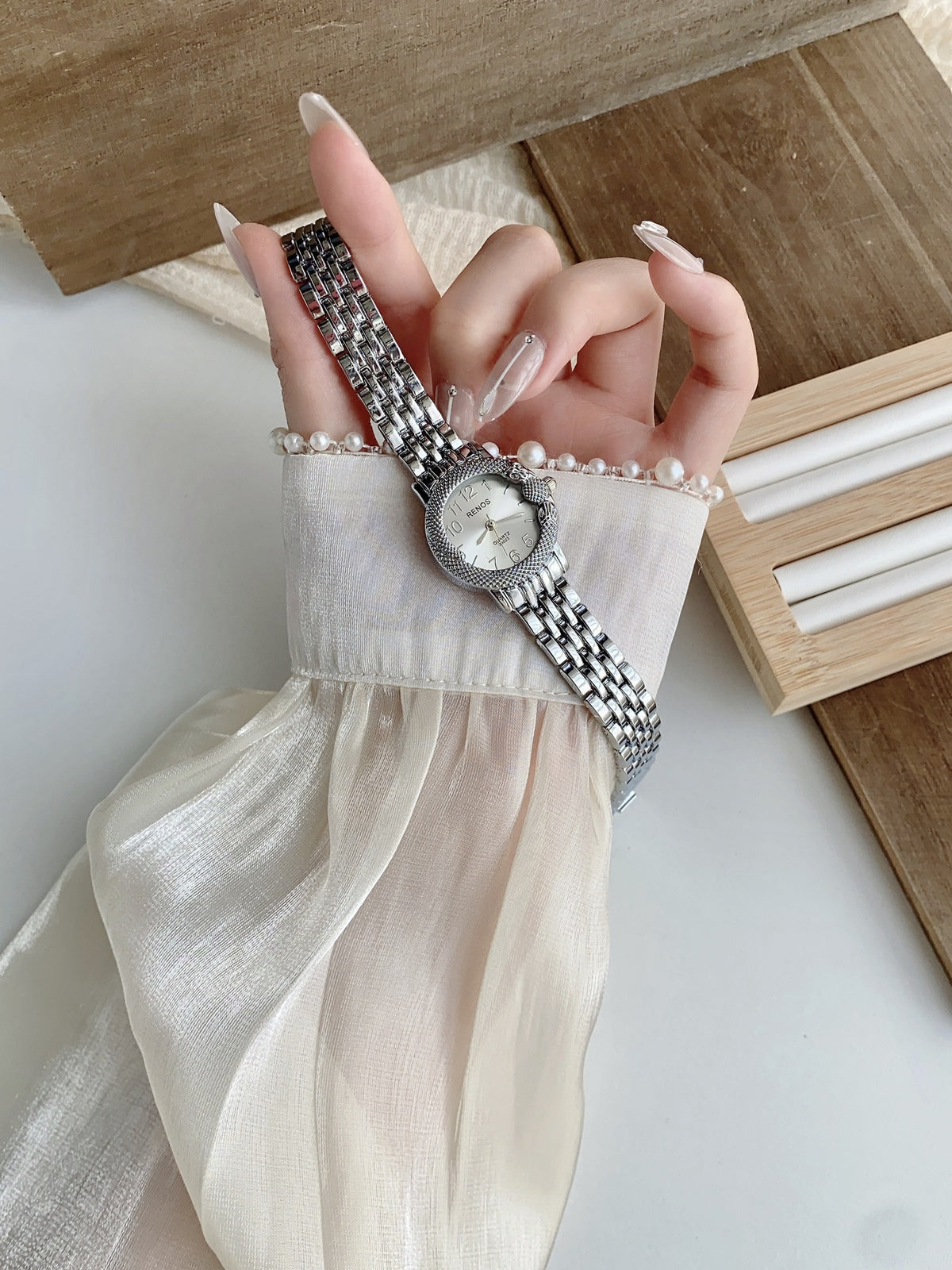 RENOS textured bezel bracelet watch in silver tone with white dial