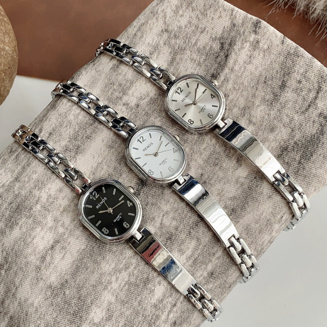 RENOS vintage cushion-link bracelet quartz watches in silver tone with black and light dials
