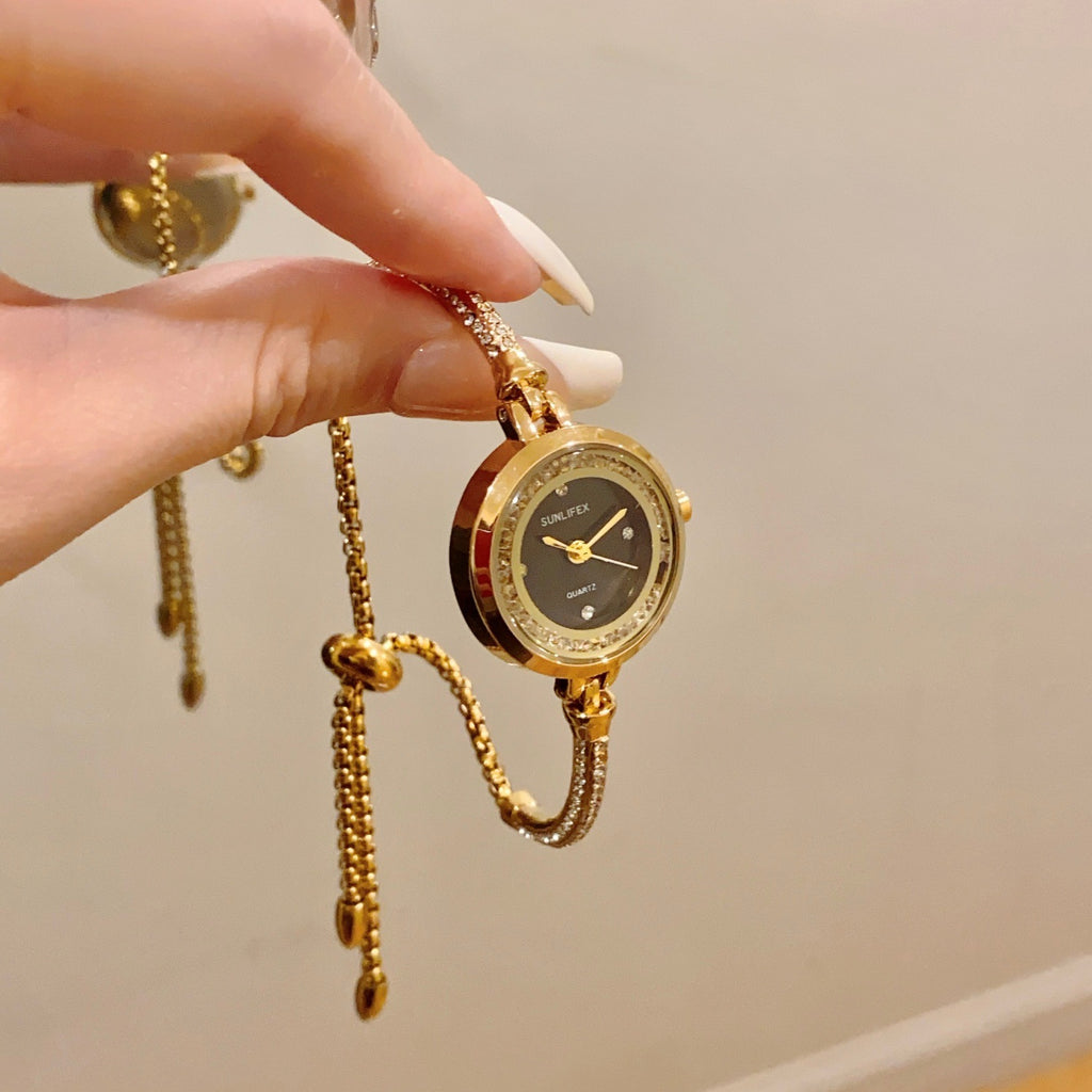 SUNLIFEX adjustable chain bracelet watch in gold tone with black dial hanging view