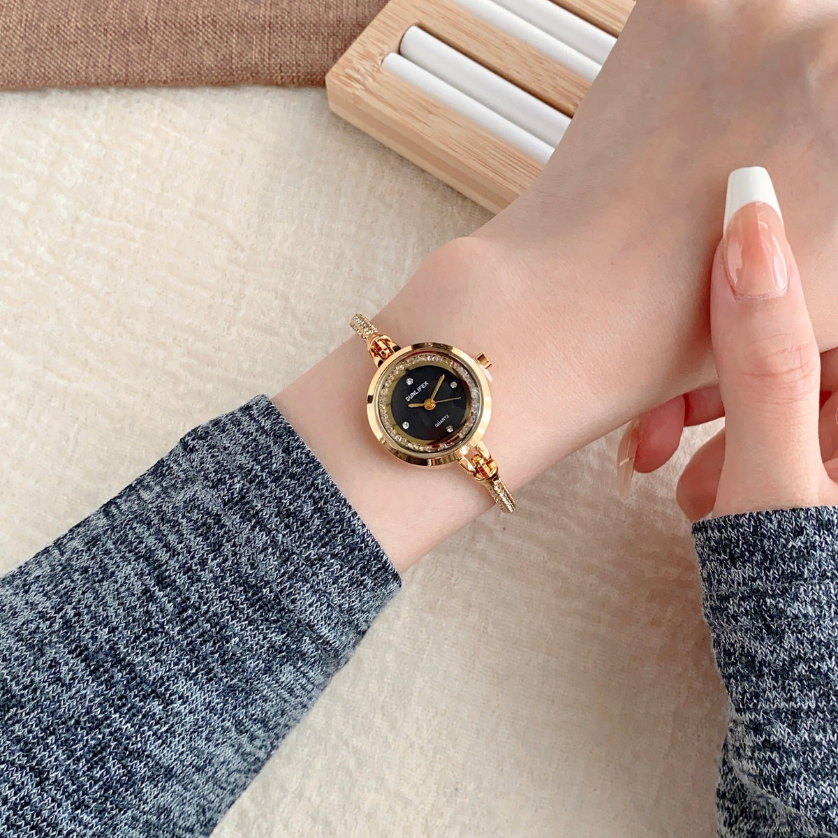 SUNLIFEX adjustable chain bracelet watch in gold tone with black dial worn on wrist