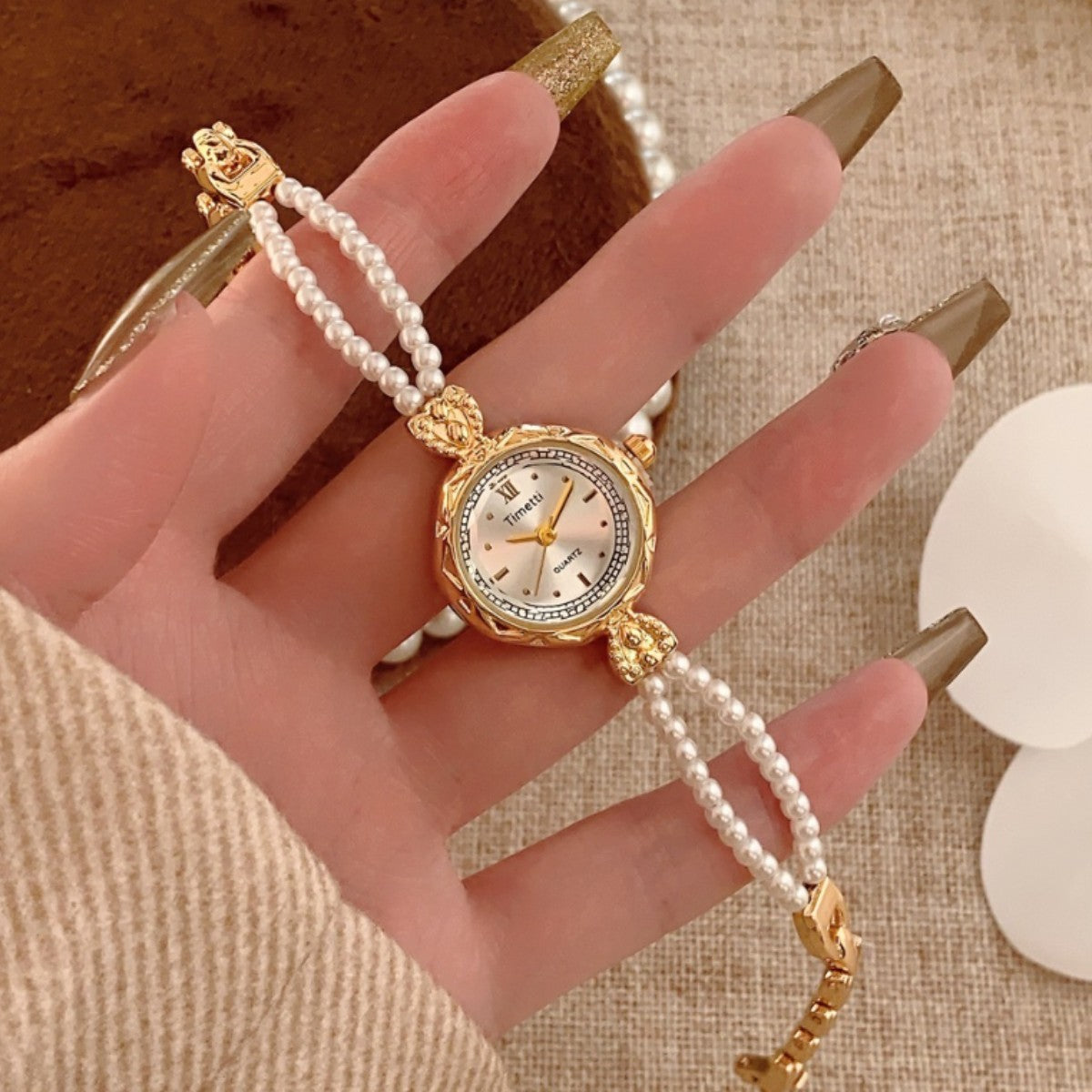 Timett double-pearl bracelet watch in gold tone hand view