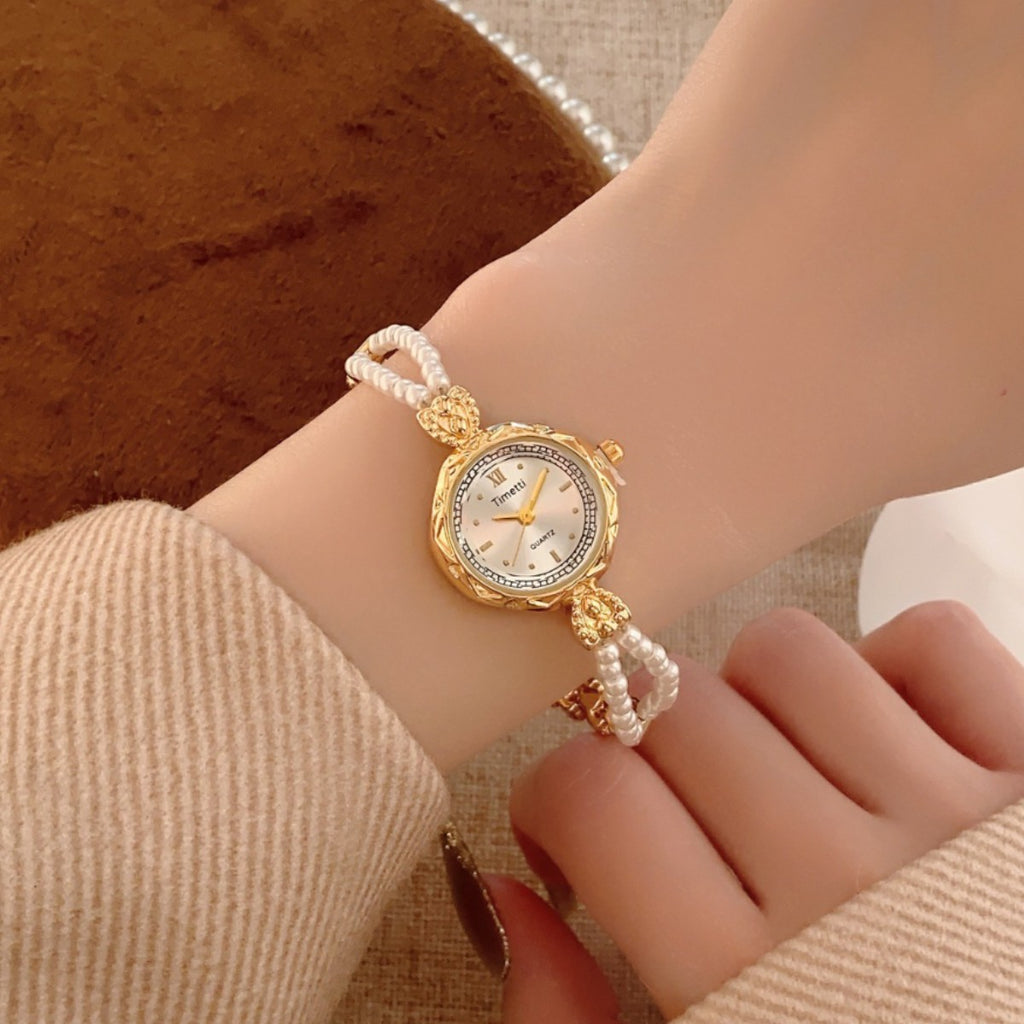 Timett double-pearl bracelet watch in gold tone worn on wrist