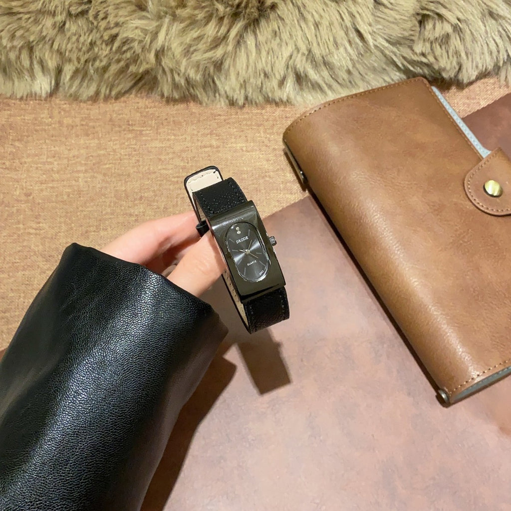 Vintage petite black tonneau women's quartz watch with textured black leather-style strap