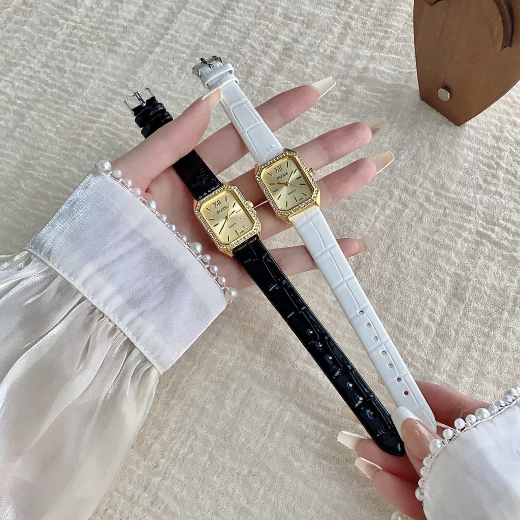 Vintage petite women's watch with crystal-style bezel shown in black and white leather-style straps