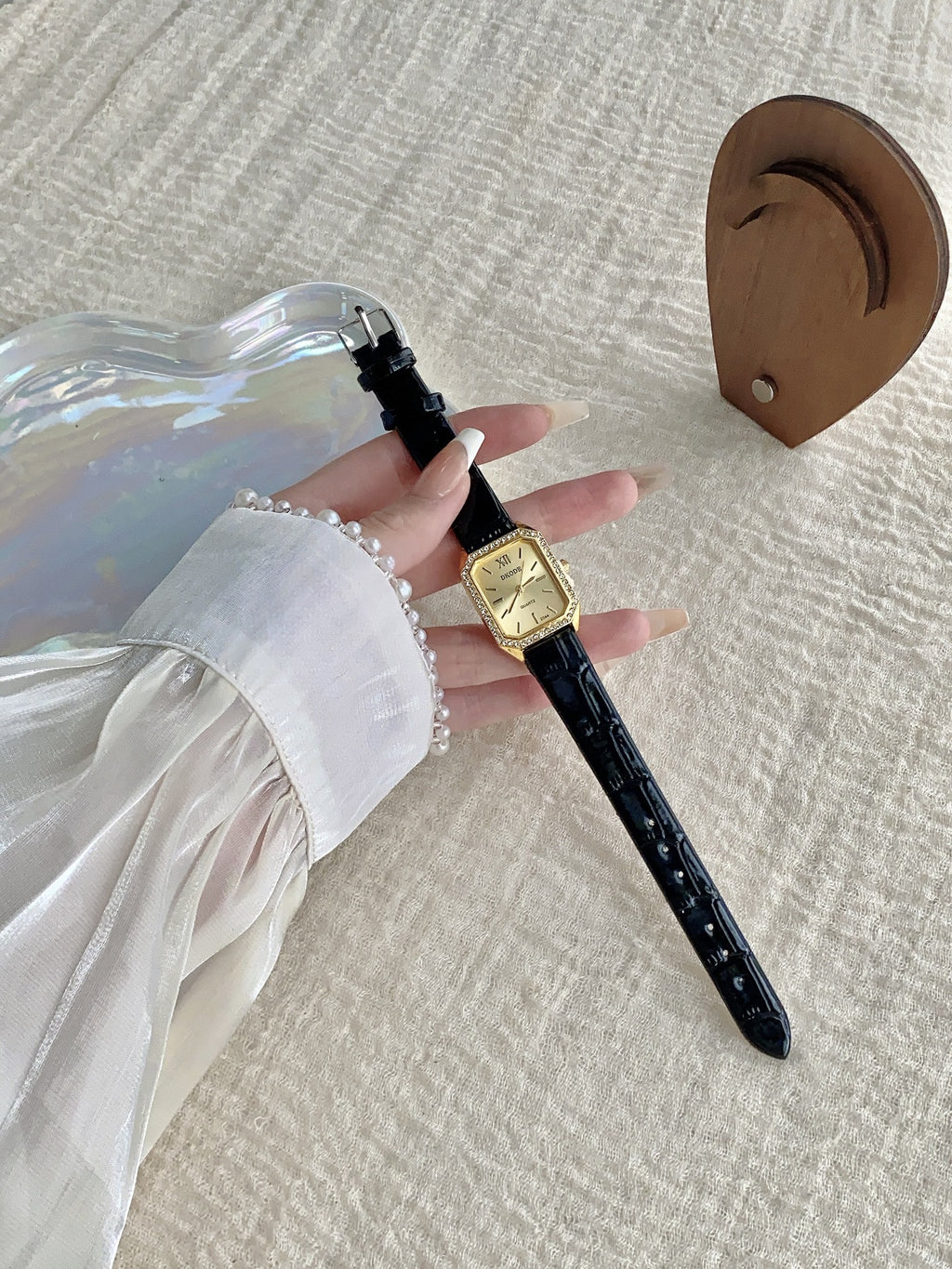 Vintage petite women's watch with crystal-style bezel and black leather-style strap