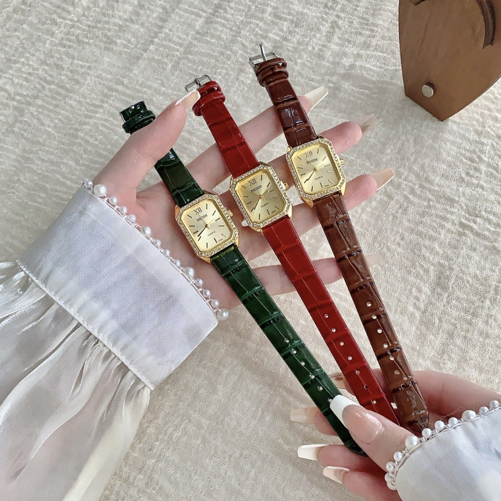 Vintage petite women's watch with crystal-style bezel shown in green, red and brown leather-style straps
