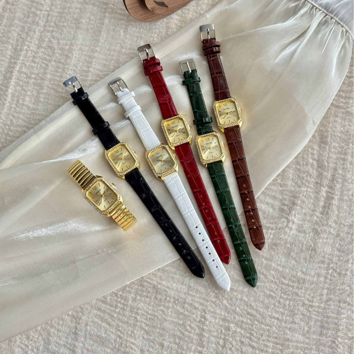 Vintage petite women's watch with crystal-style bezel in multiple leather-style straps and gold stretch bracelet