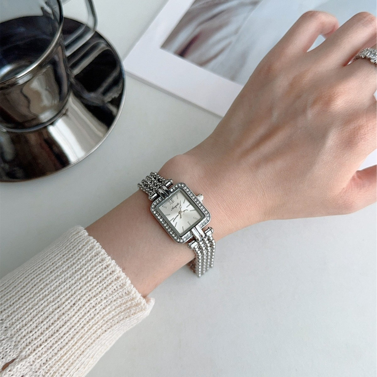 Vintage silver-tone square crystal-style jewelry bracelet quartz watch worn on wrist