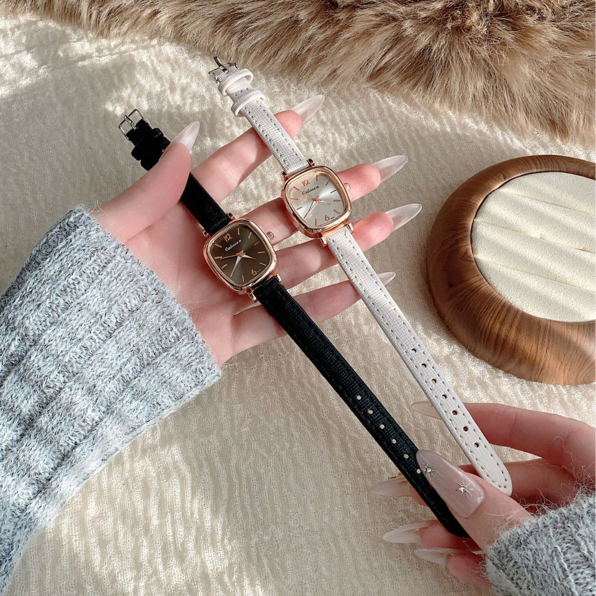 Vintage women's cushion case quartz watch shown in black and white leather-style straps