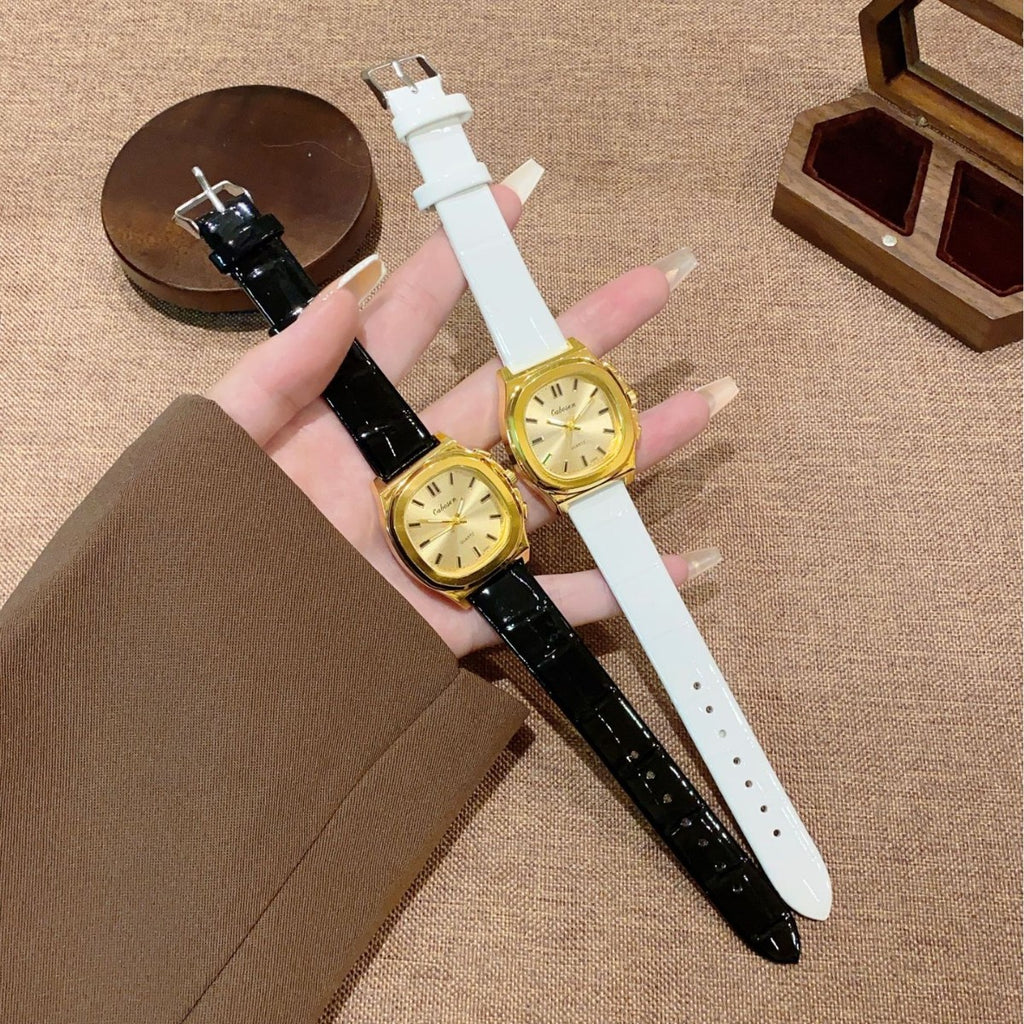 Vintage gold-tone cushion women's watch shown in black and white croc-embossed leather-style straps