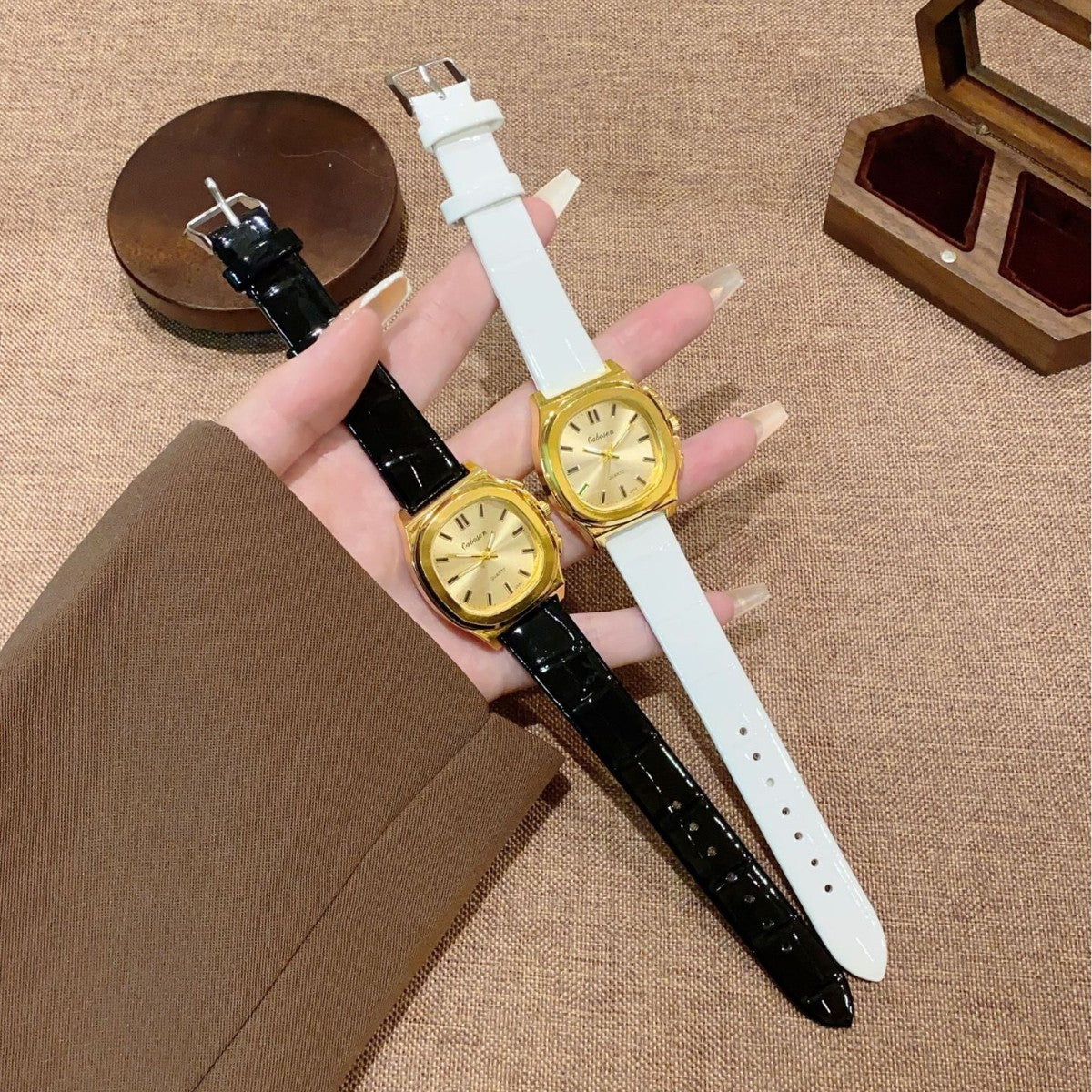 Vintage gold-tone cushion women's watch shown in black and white croc-embossed leather-style straps