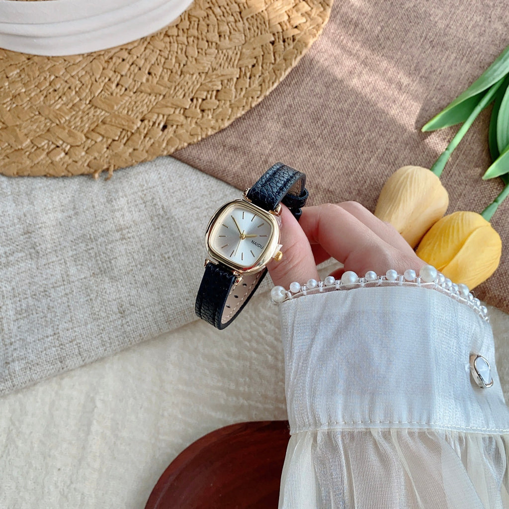 Black strap petite rounded-square women's watch in a folded product view
