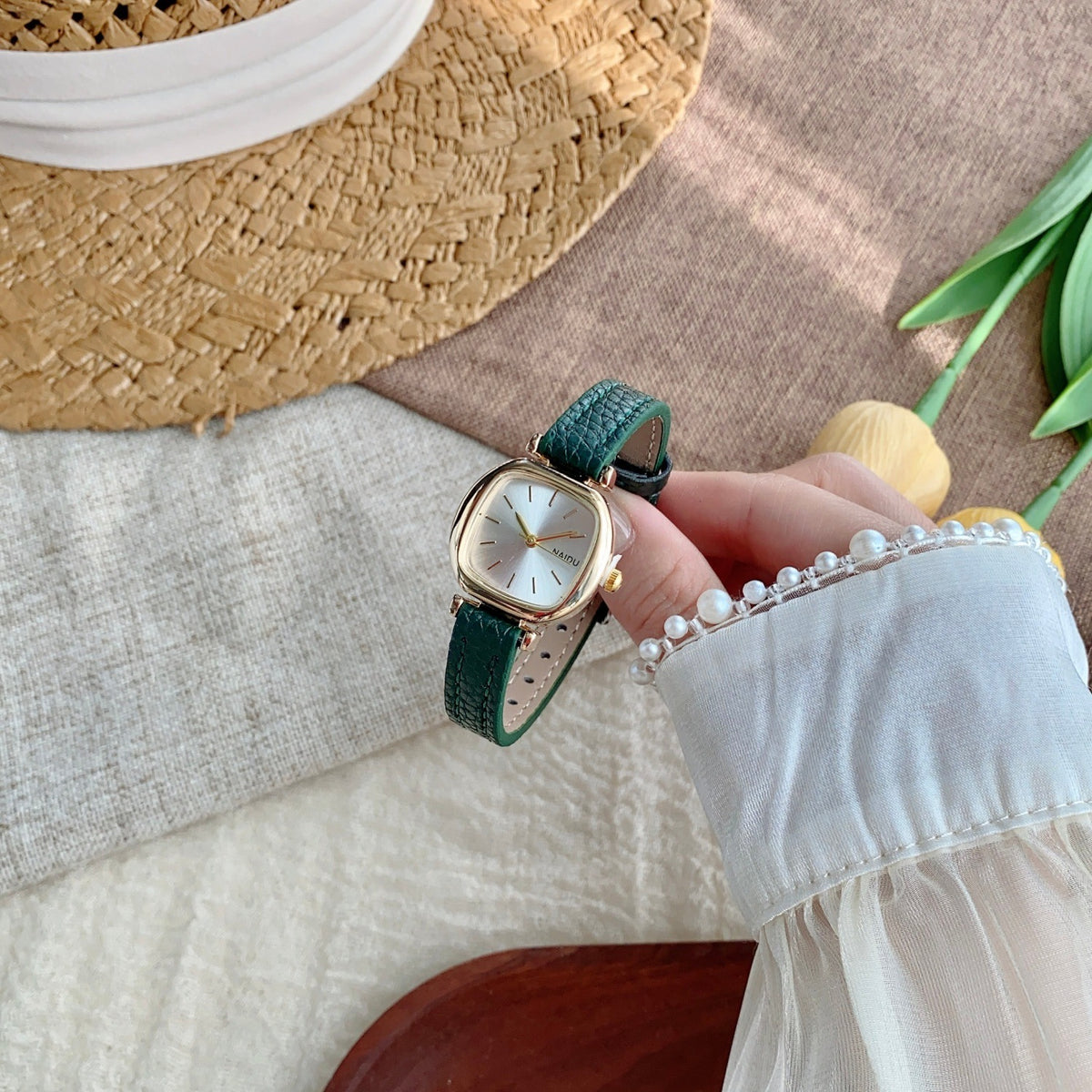 Green strap petite rounded-square women's watch in a folded product view