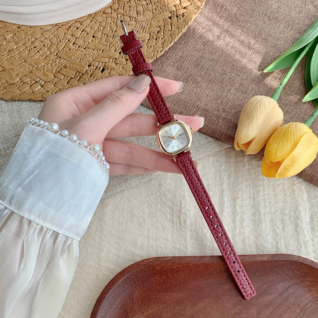 Petite rounded-square women's watch with red leather-style strap and light dial