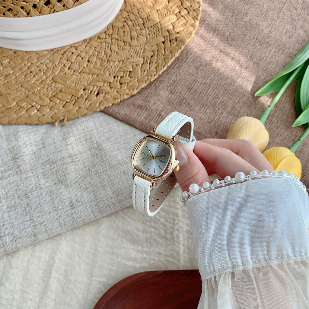 White strap petite rounded-square women's watch in a folded product view