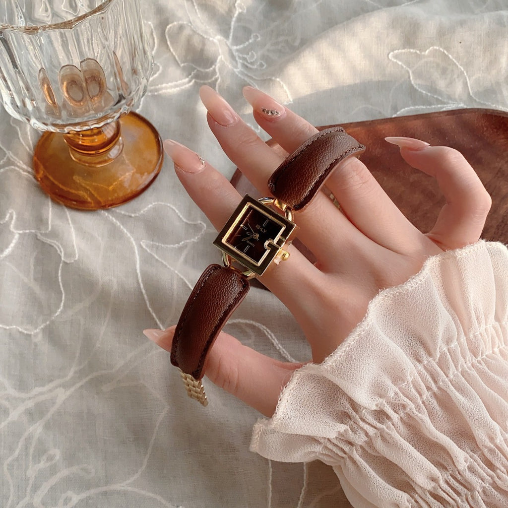 Vintage gold square women's brown leather watch styled on wrist