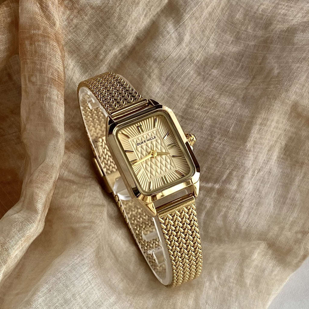 Women's vintage square quartz watch with gold-tone woven steel bracelet and champagne dial