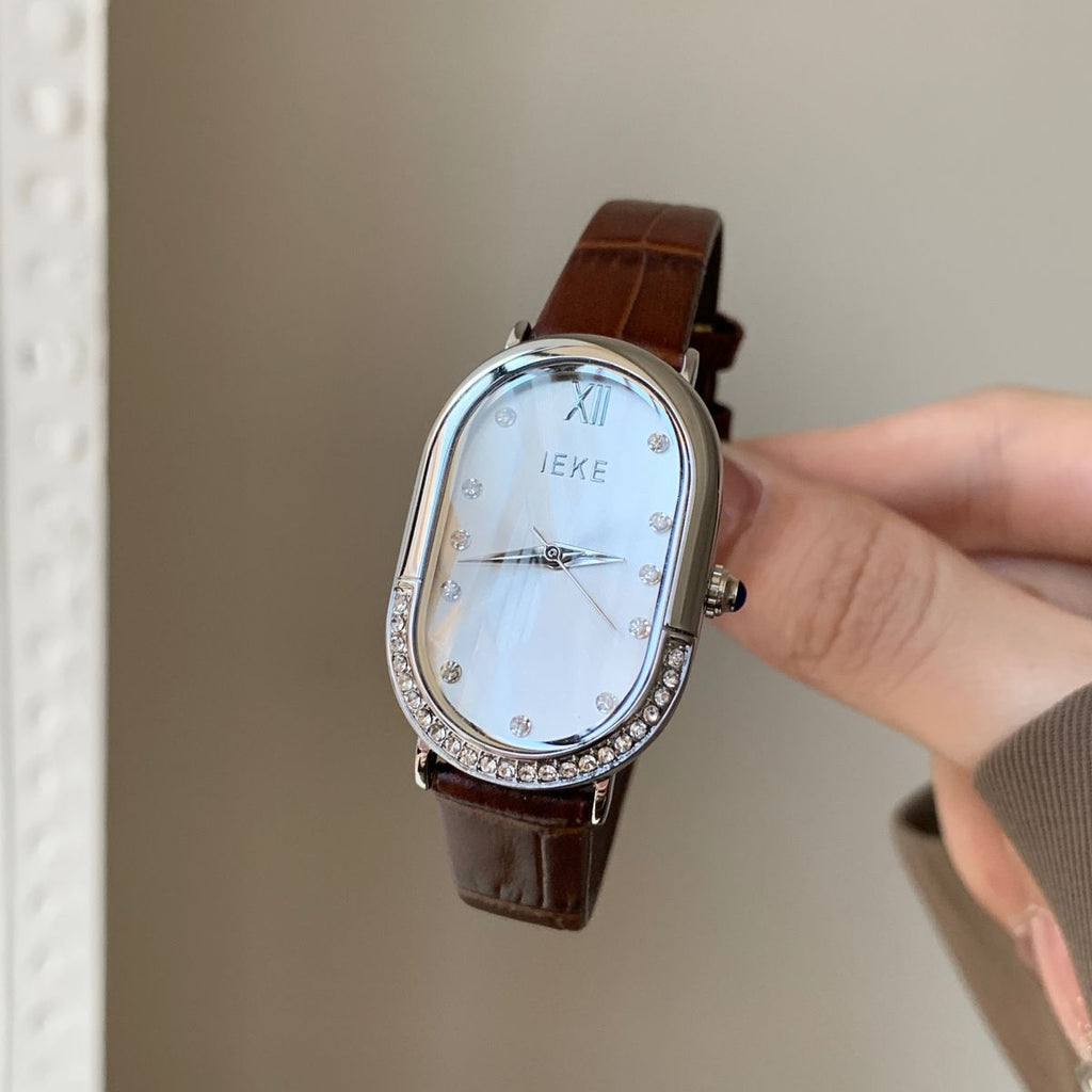 Retro Sculpted Oval Dial Watch with Slim Leather Strap - Elegant Dress Watch for Women
